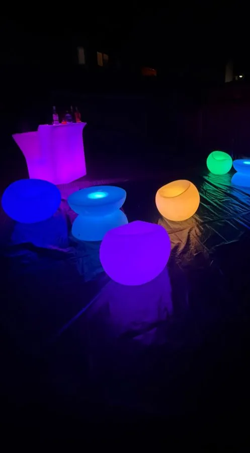 LED glow bar with colour-changing chairs and tables outdoors at night