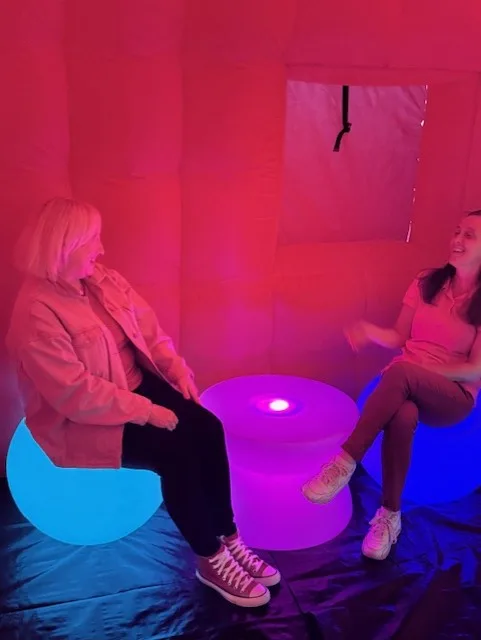 Guests relaxing on glowing LED seats inside a VenYou tent