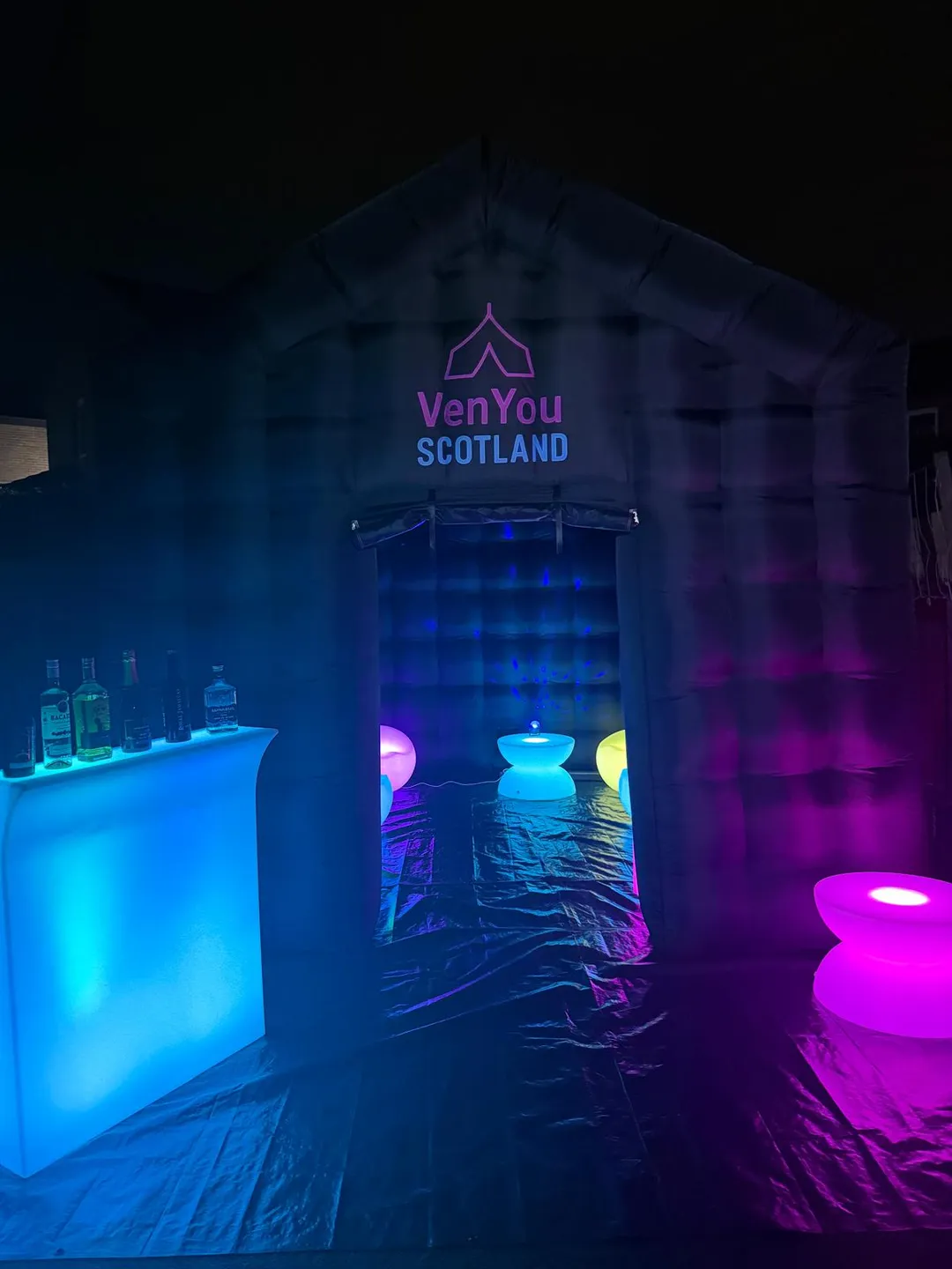 LED bar, glow tables and chairs at the entrance of a VenYou party tent